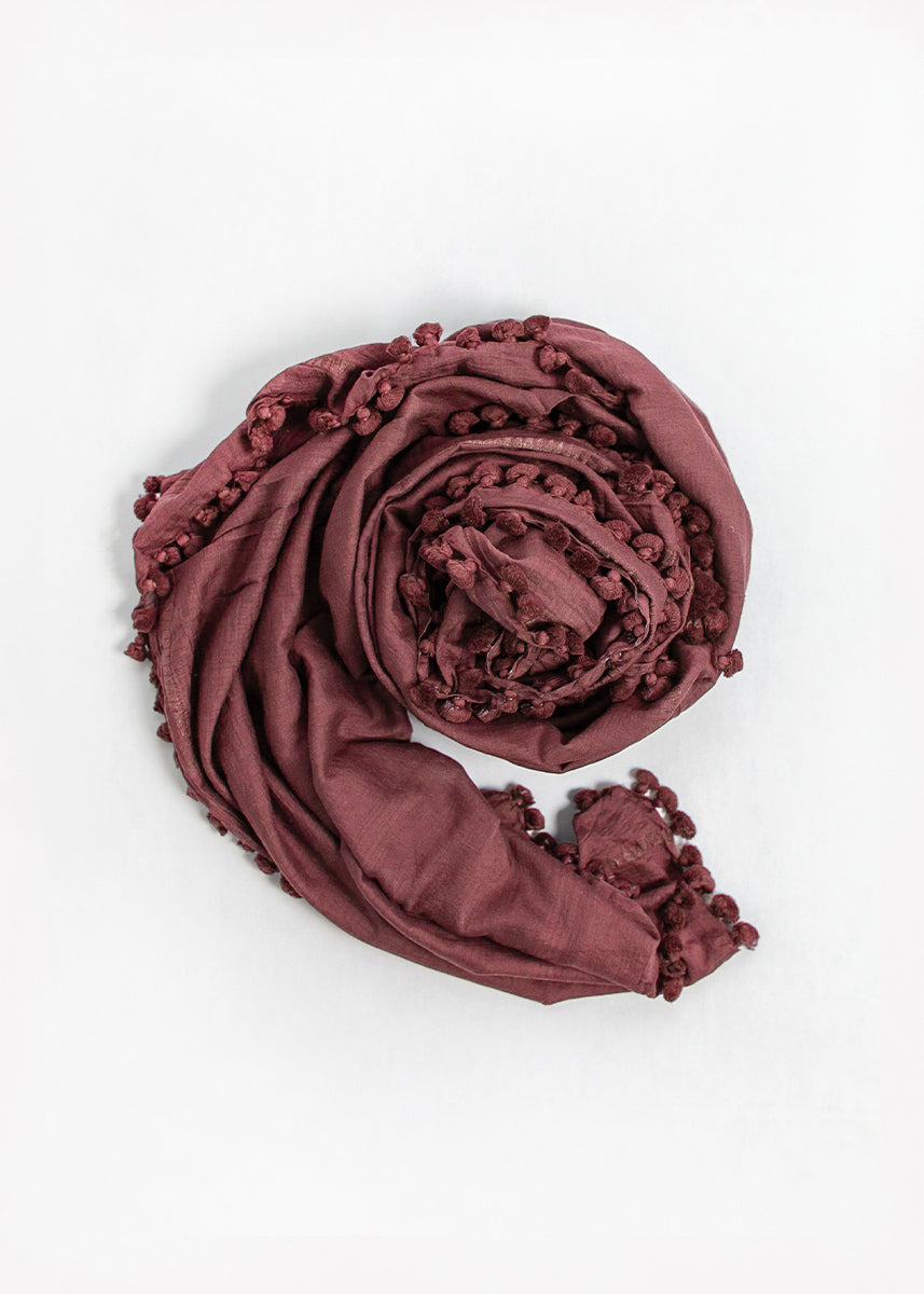 Maroon shawl with tassels on a white background